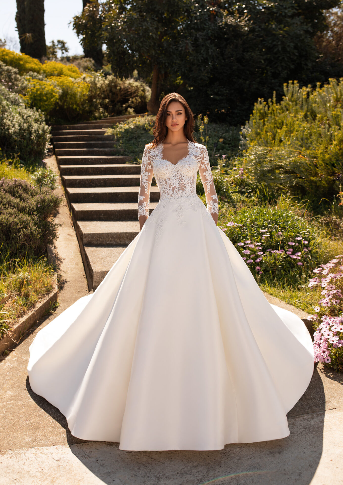 A woman in a white dress standing on some steps