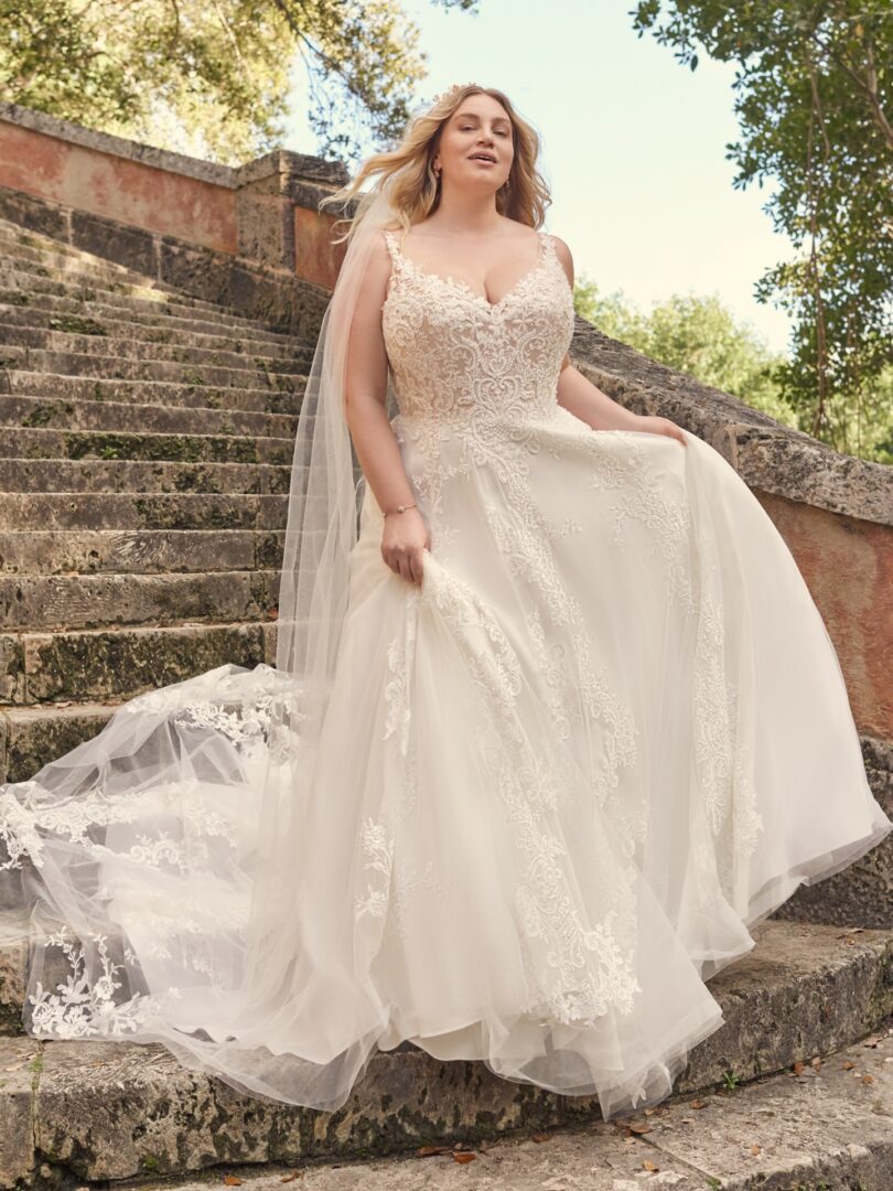 A woman in a wedding dress standing on some steps