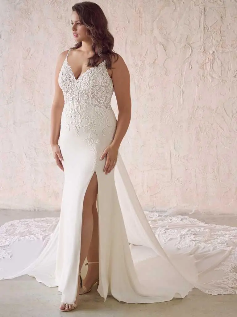 A woman in a white dress standing on top of a floor.