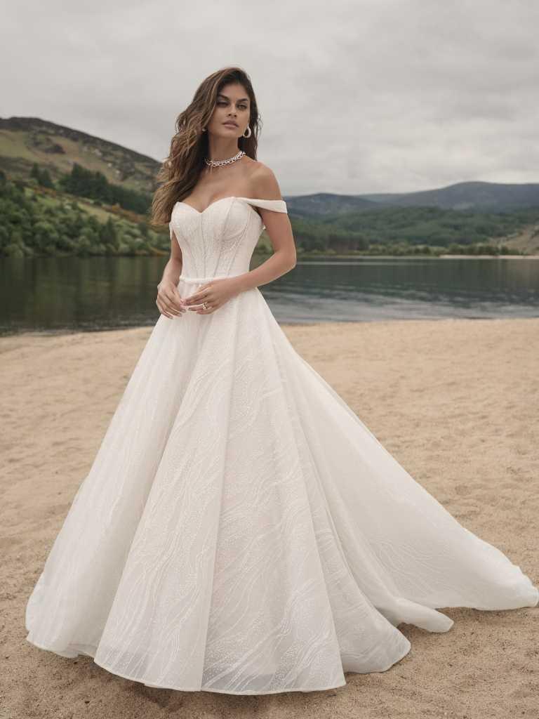 A woman in a white dress standing on the beach