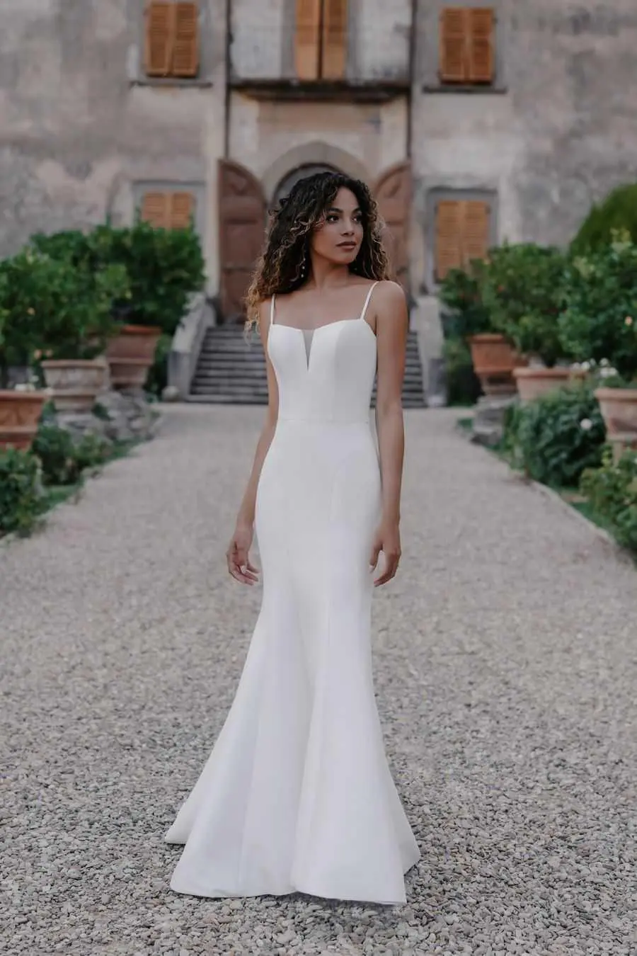 A woman in white dress standing on the ground.