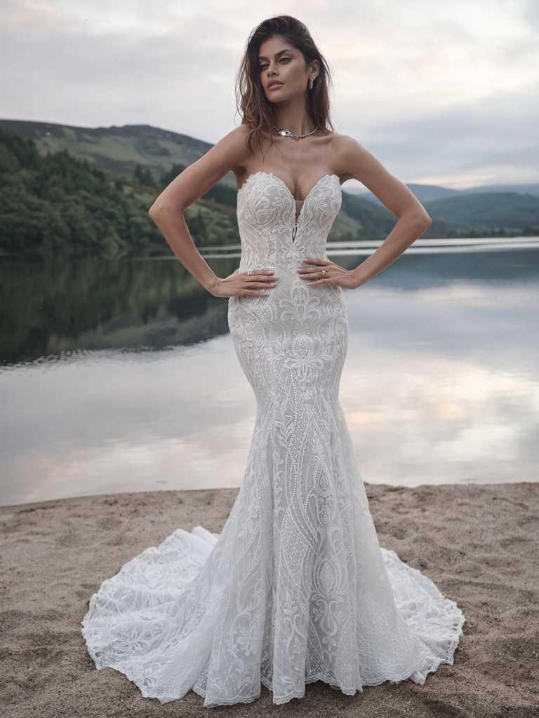 A woman in a white dress standing on the beach