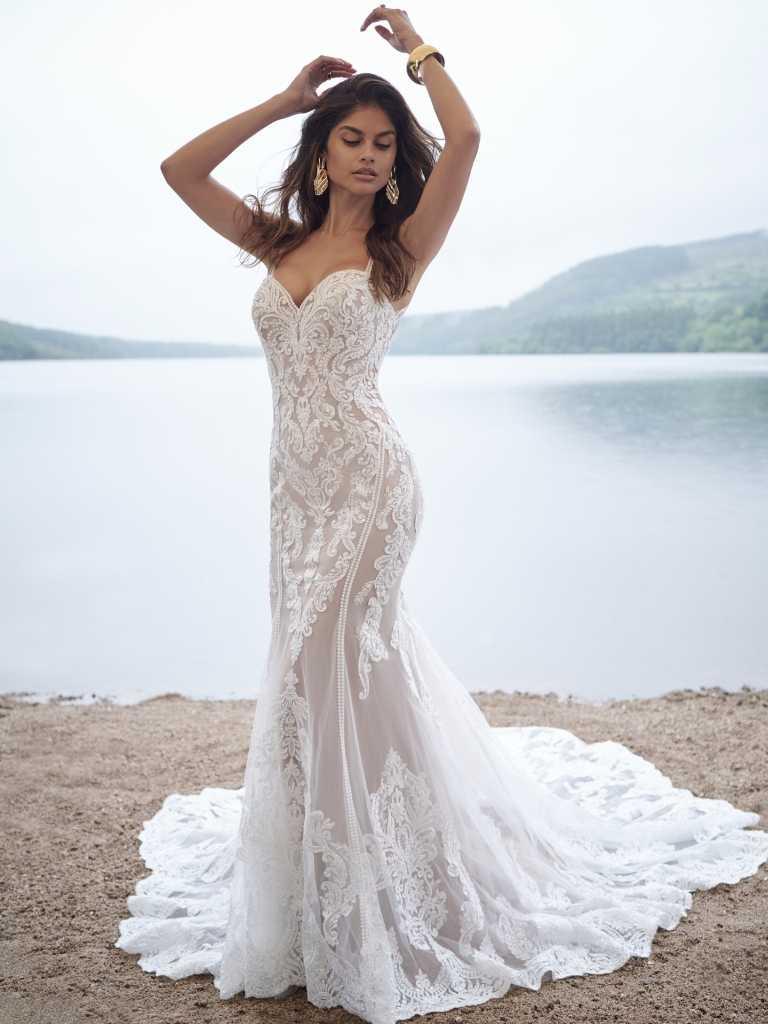 A woman in a white dress standing on the beach