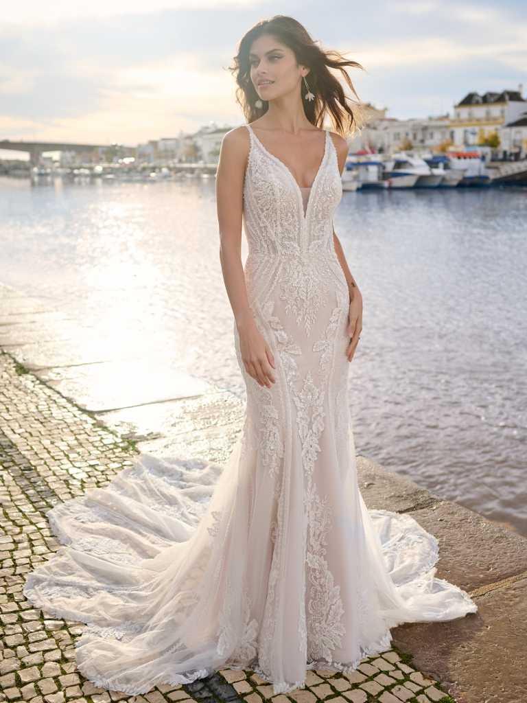 A woman in a white dress standing on the beach