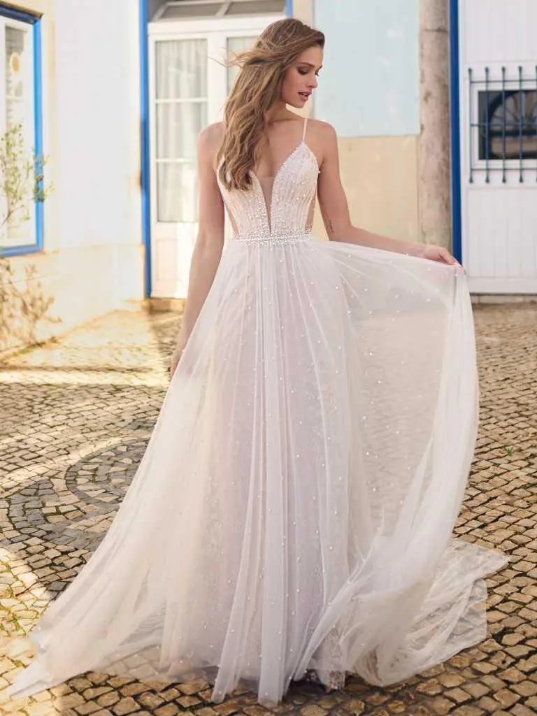 A woman in a white dress standing on the street.