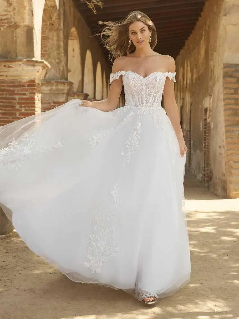 A woman in a white dress is standing outside