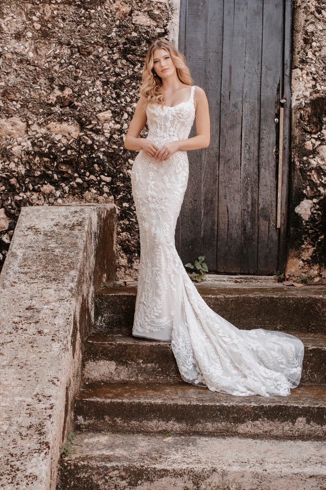 A woman in a white dress standing on some steps