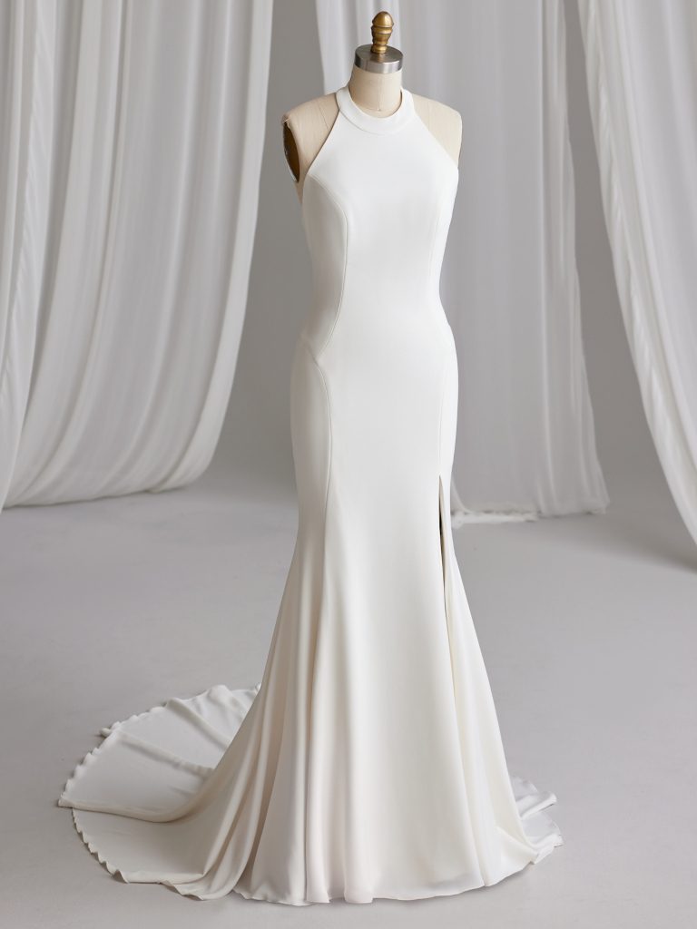 A white dress is standing in front of some drapes